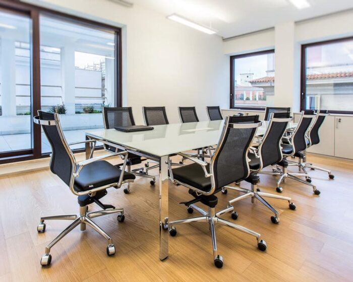 Havana Mini Medium back managers chair and boardroom chair in black leather and black mesh upholstery around a glass meeting table