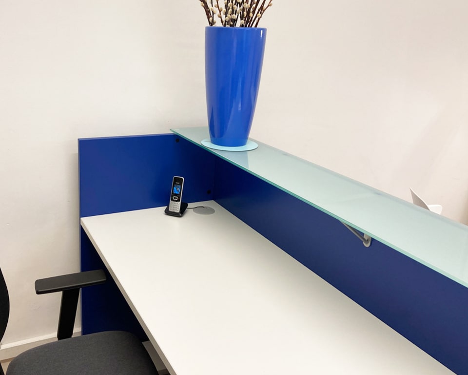 Luxury high -end small reception desks- BG compact reception desks are part of the larger modular range of Italian designer desks for office reception areas and break out seating areas. These stylish desks shown here in matt blue lacquer are available in 4 sizes 1800 mm wide, 1600mm , 1400 mm and 1200 x 630 x 1080mm high. They all have a laminated glass counter top. The desk top includes 2 cable ports for cable egress onto the desk surface. An excellent compact reception desk for small or large office reception areas.