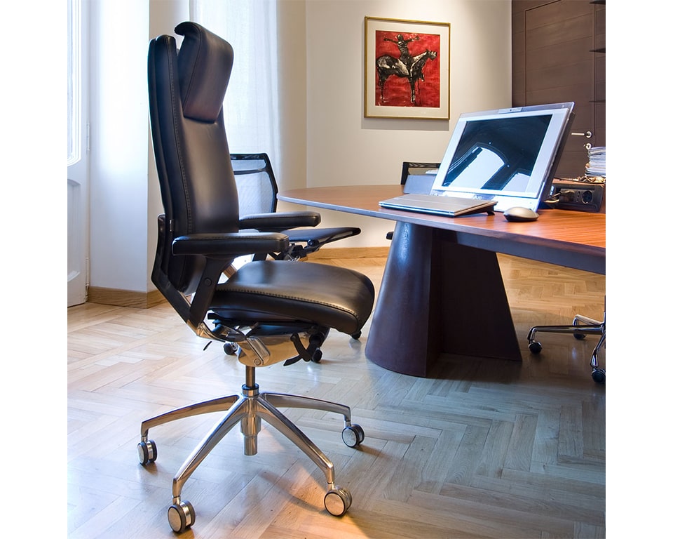 High back ergonomic executive chair with headrest and upholstered arms. Lumbar support. Black leather version