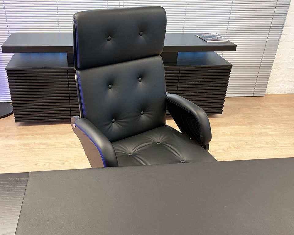 Nesi High back executive chair. Upholstered in black leather with leather covered buttons. Diew cast aluminium base and black ash outer back and arms