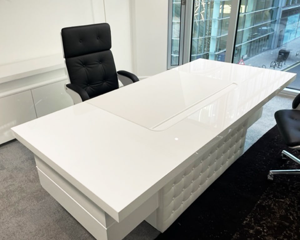 white gloss executive office desk with a white leather buttoned modesty panel shown with matching white gloss executive chairs - Taiko and Nesi ranges