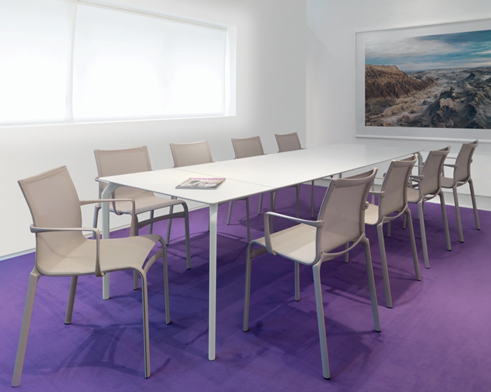 Big Frame 44 meeting chairs with arms upholstered in mesh shown with TEC white meeting tables