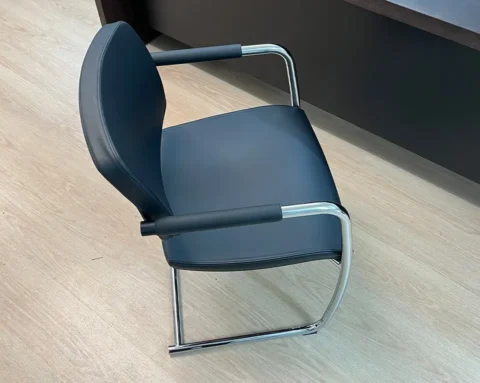 Luxury conference room chairs in black leather with leather arm pads