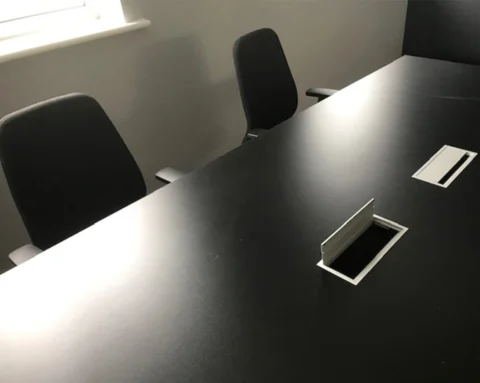 Stunning black meeting room table with top access boxes