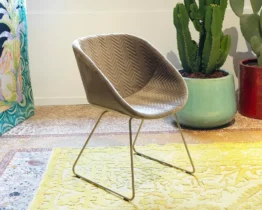 tub chair upholstered in fabric on a skid frame