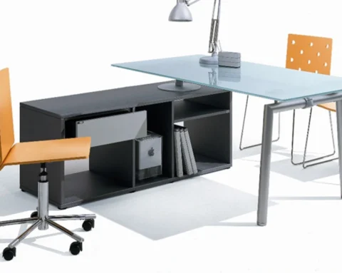 L- shaped glass desk with a lower side return