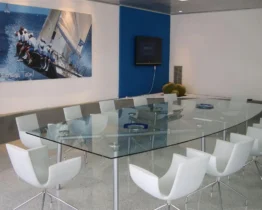 bespoke glass boardroom table with a boat shaped glass top