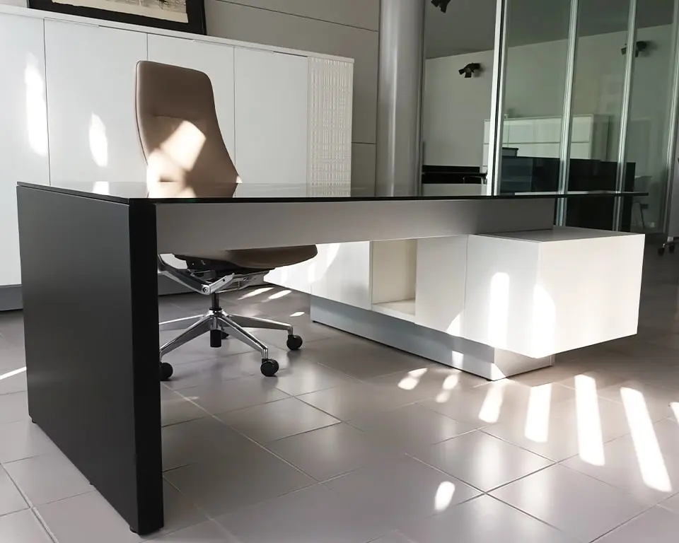 stylish l- shaped executive desk with a black glass desk top