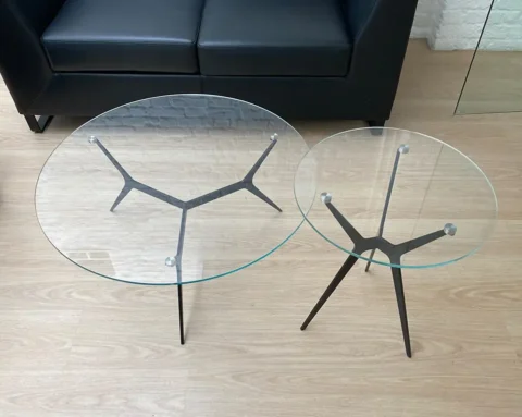 Round glass coffee tables with a black tripod frame
