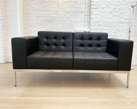 Executive two seat sofa in black leather with upholstered buttons