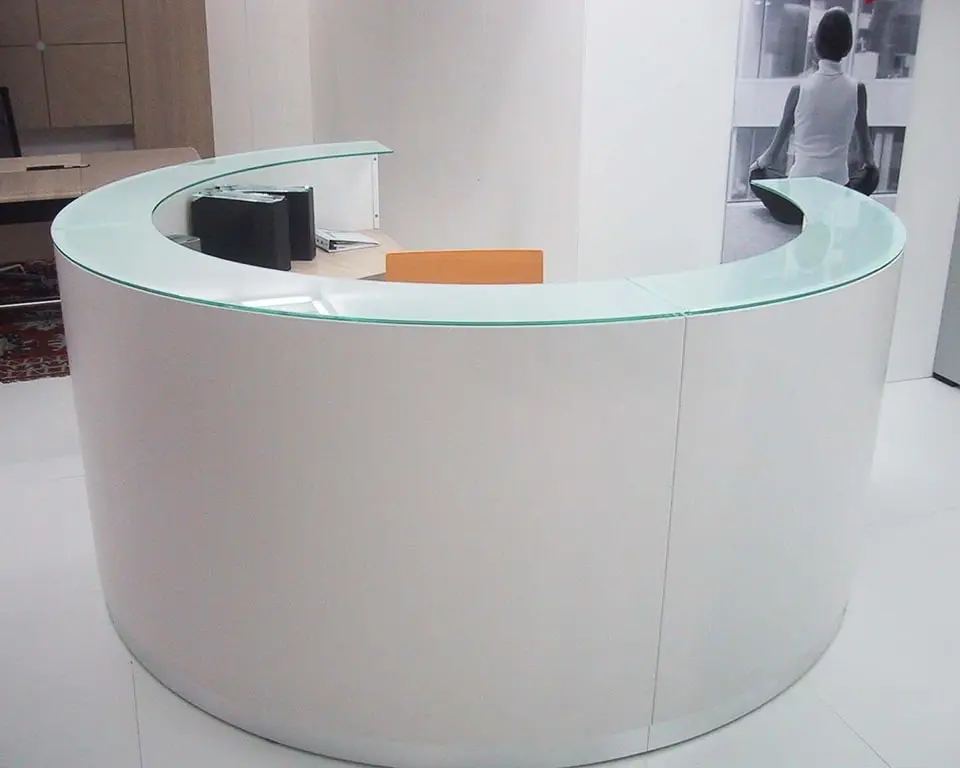 white circular reception desk made up of 3 curved modules