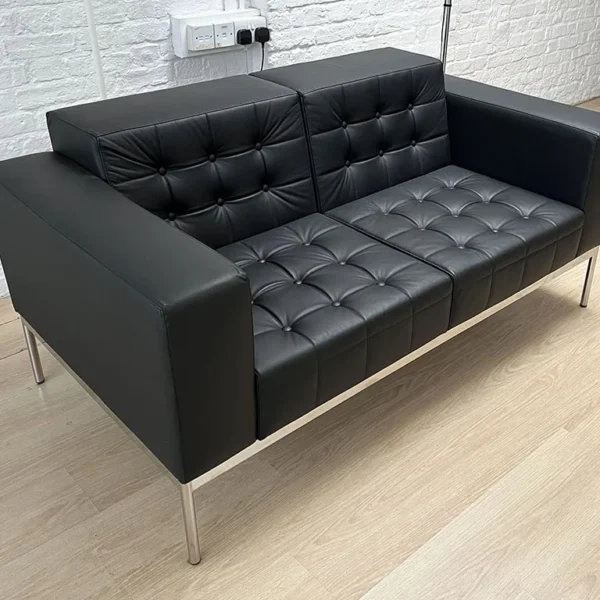 Black Leather two seat sofa with buttons and a chrome frame