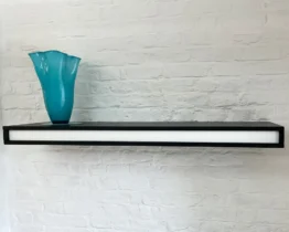 a stylish wall mounted shelf in matt black lacquer